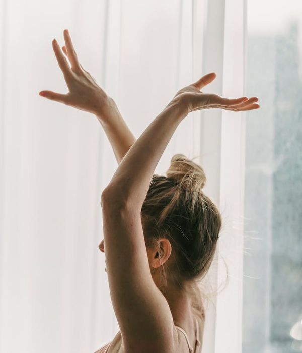 Woman in a graceful yoga pose with soft light accents.